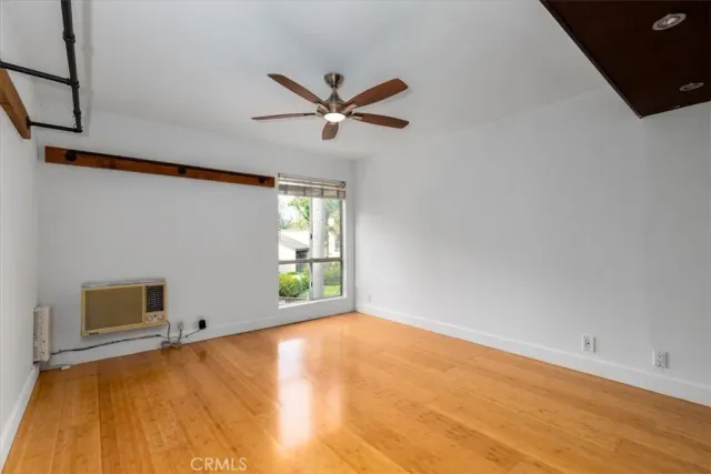 a bedroom with a bed and a ceiling fan