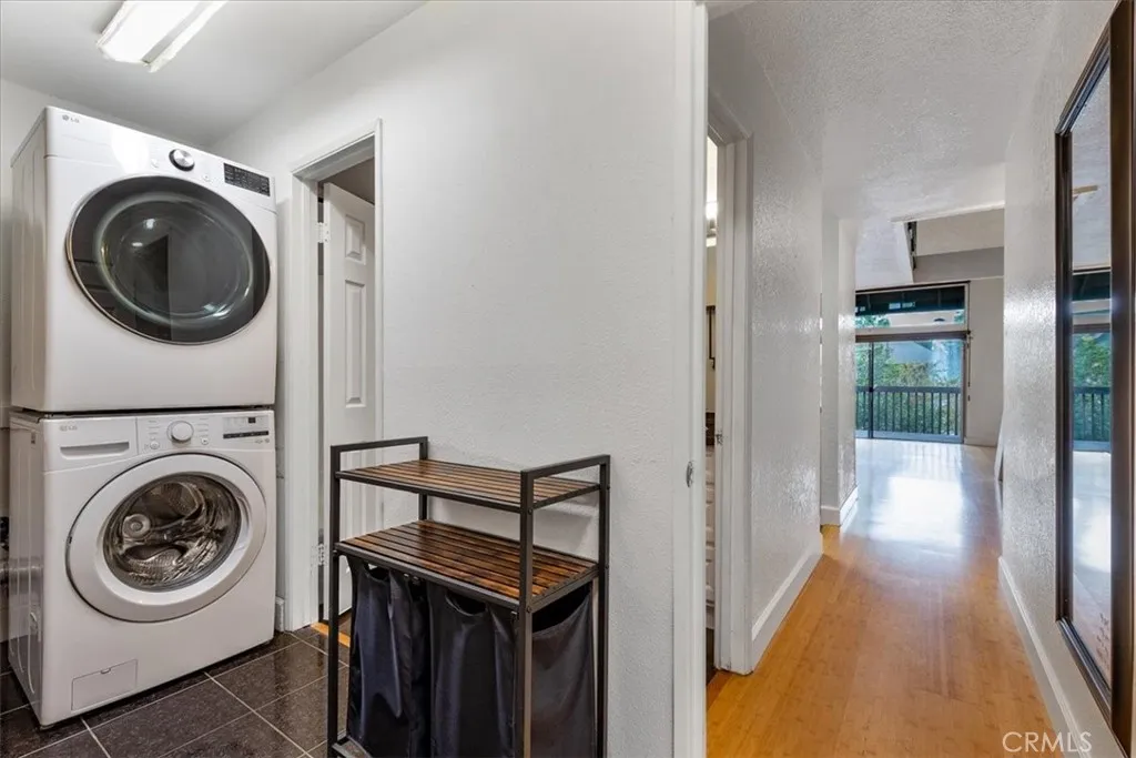 7890 East Spring Street, Unit 18F Long Beach, CA 90802 - Photo 15 of 31 a view of a hallway with washer and dryer