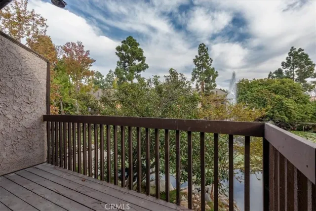 a balcony with wooden floor and fence