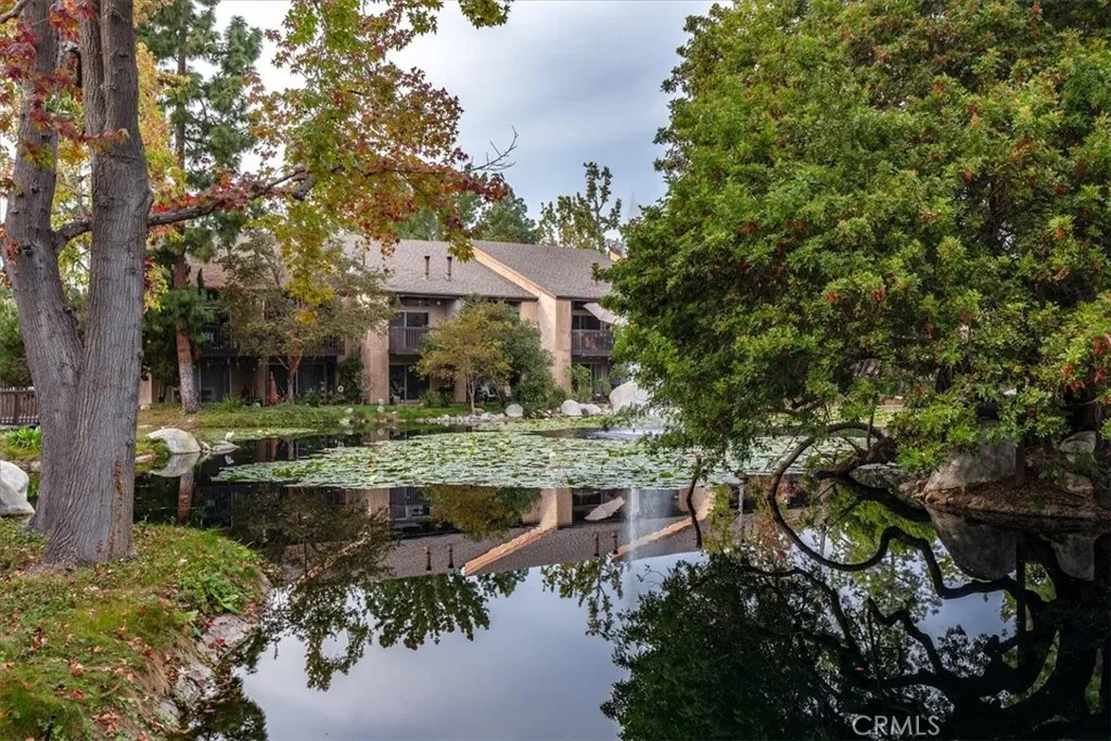 7890 East Spring Street, Unit 18F Long Beach, CA 90802 - Photo 19 of 31 a view of house with a yard and potted plants