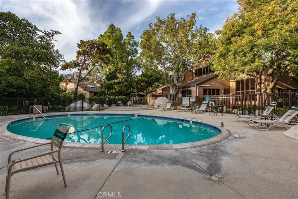 7890 East Spring Street, Unit 18F Long Beach, CA 90802 - Photo 24 of 31 a swimming pool with outdoor seating and yard