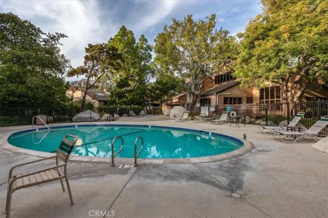 a view of swimming pool with a patio and a garden