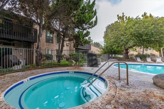 a view of pool with a yard