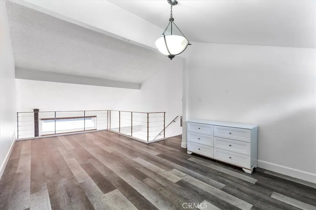 7890 East Spring Street, Unit 18F Long Beach, CA 90802 - Photo 8 of 31 a view of an empty room and wooden floor