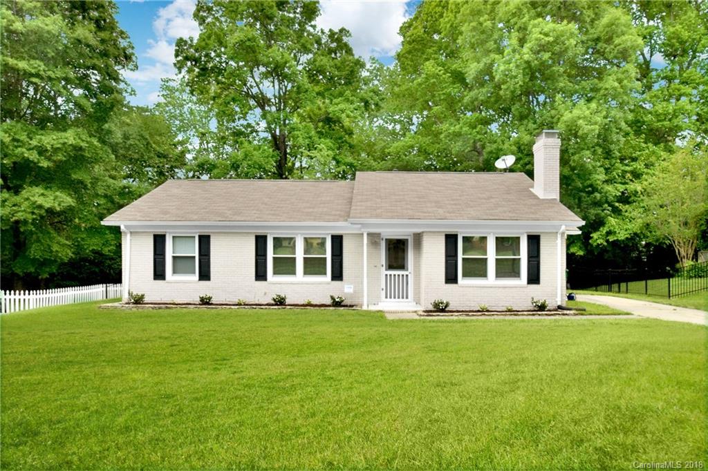 a front view of house with yard outdoor and green space