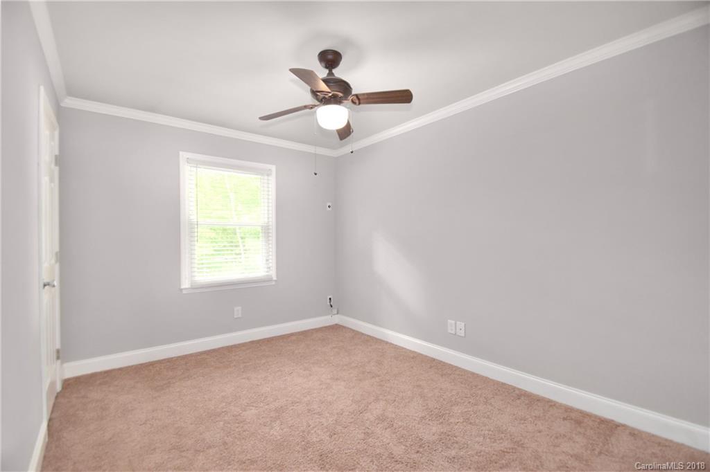 6426 Round Hill Road Charlotte, NC 28211 - Photo 11 of 23 an empty room with a window and a fan