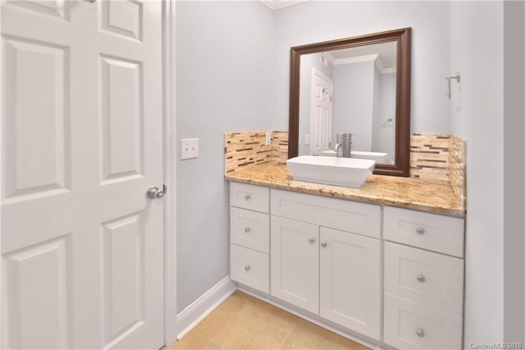 6426 Round Hill Road Charlotte, NC 28211 - Photo 12 of 23 a bathroom with a granite countertop sink and a mirror
