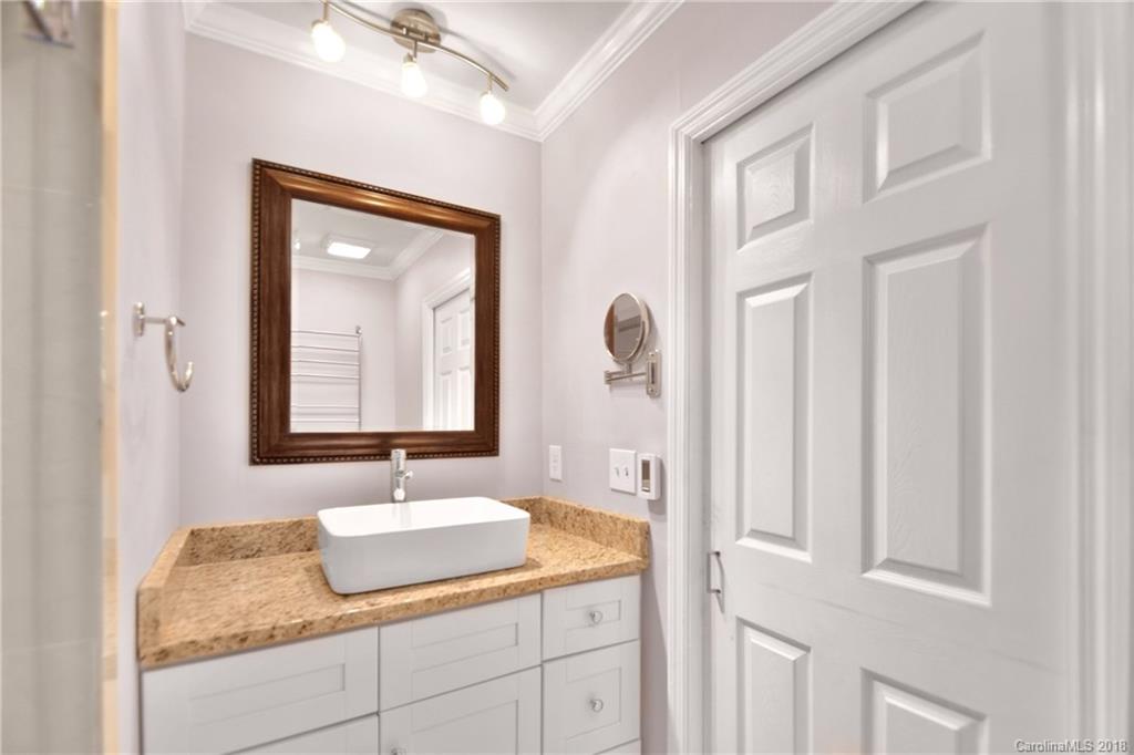 6426 Round Hill Road Charlotte, NC 28211 - Photo 13 of 23 a bathroom with a granite countertop sink and a mirror