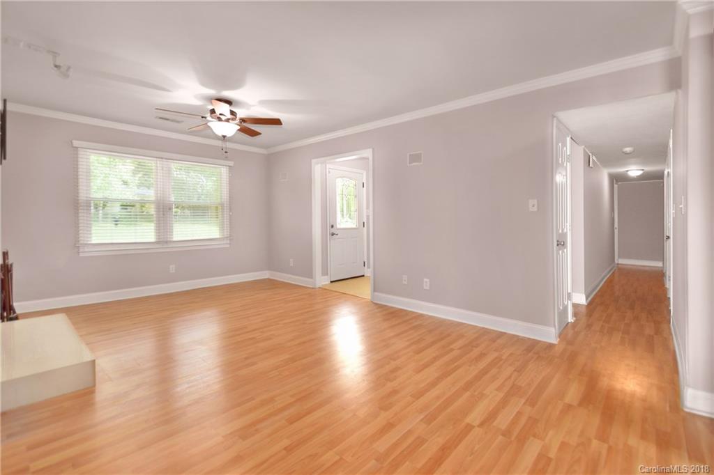 6426 Round Hill Road Charlotte, NC 28211 - Photo 6 of 23 a view of an empty room with wooden floor and a window