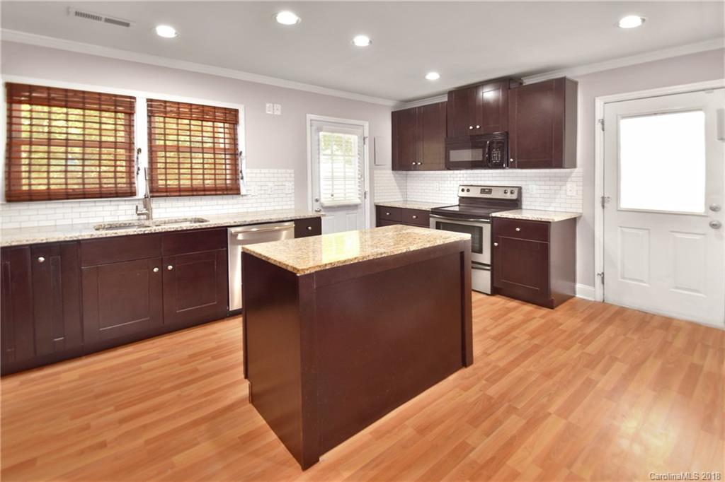 6426 Round Hill Road Charlotte, NC 28211 - Photo 9 of 23 a large kitchen with stainless steel appliances granite countertop a sink and cabinets