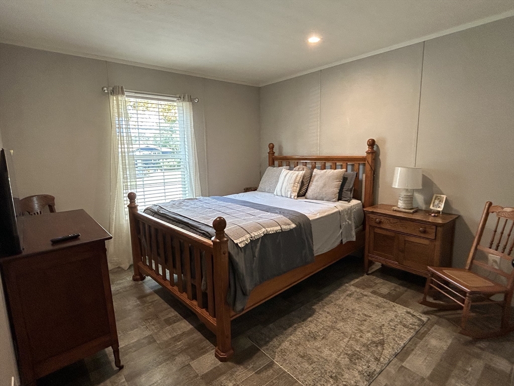 41 Longboat Road Wareham, MA 02576 - Photo 4 of 15 a bedroom with a bed and wooden floor