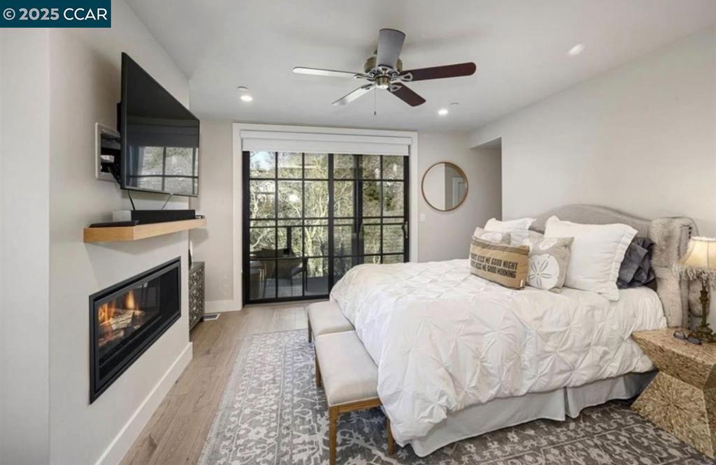 Undisclosed Address Alamo, CA 94507 - Photo 3 of 8 a bedroom with a bed a fireplace and a flat tv screen