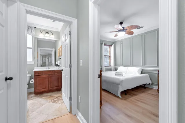a bedroom with bed and wooden floor