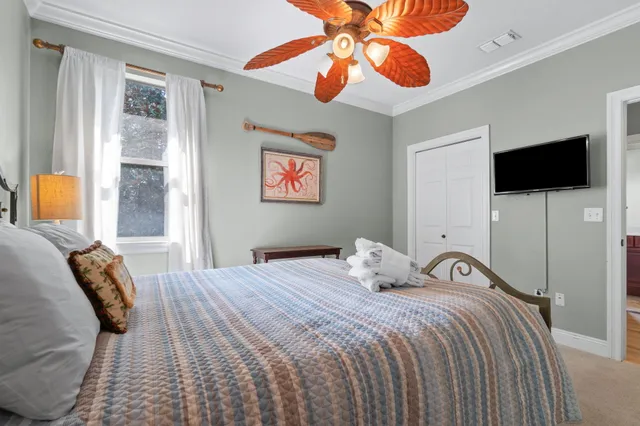 a bedroom with a bed and a chandelier