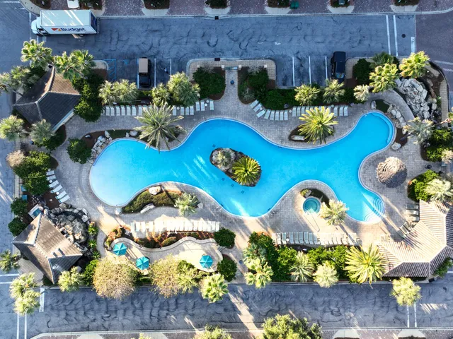 an aerial view of a house with a swimming pool yard and outdoor seating