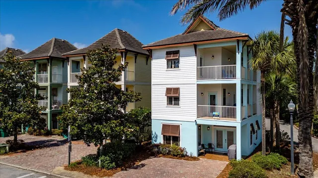 a front view of a house with plants