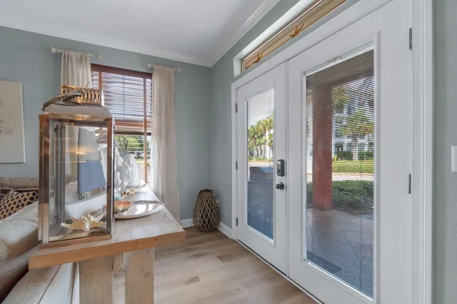 a view of a livingroom with wooden floor and a porch