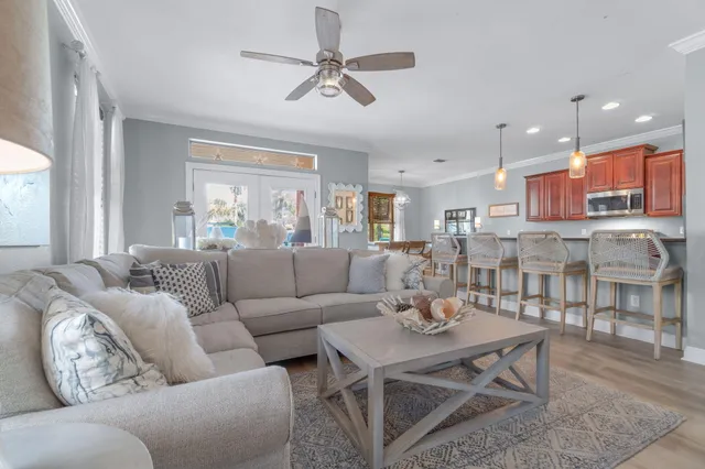 a living room with furniture kitchen view and a window