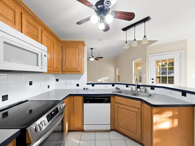 a kitchen with stainless steel appliances granite countertop a sink and cabinets