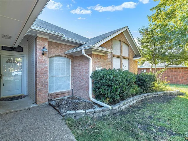 a front view of house with yard and trees