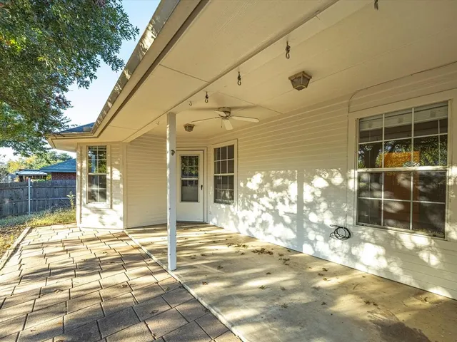 a view of a house with wooden fence