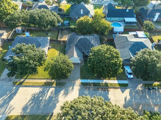 a view of a swimming pool with a patio and a yard