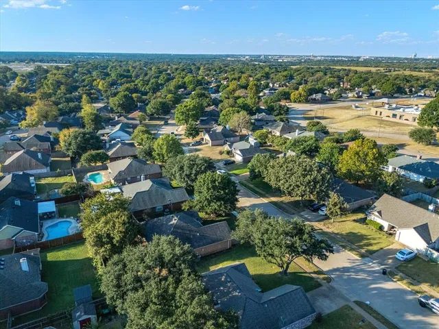 an aerial view of residential houses with outdoor space and river