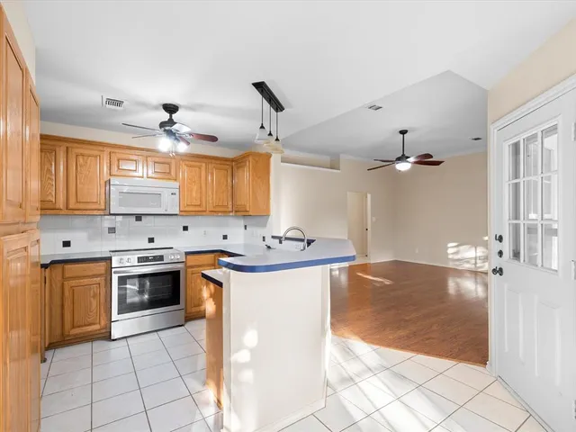 a kitchen with a sink a stove and cabinets