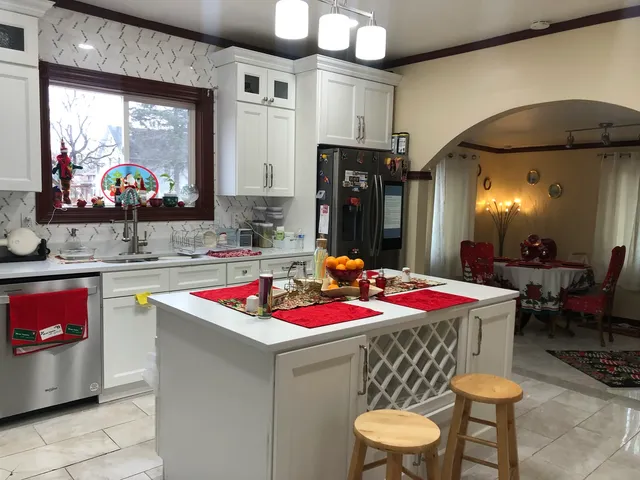 a kitchen with a stove a table and chairs