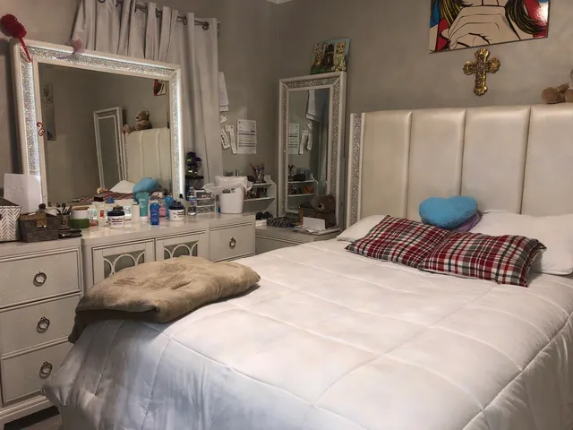 a bedroom with a bed and dresser