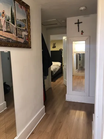 a view of a hallway view with wooden floor and staircase