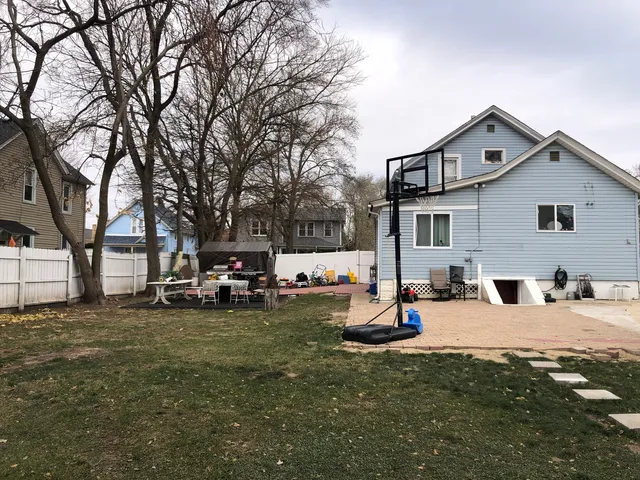 a view of a house with a yard and sitting area