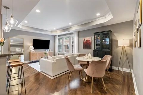 a living room with furniture a flat screen tv and a large window