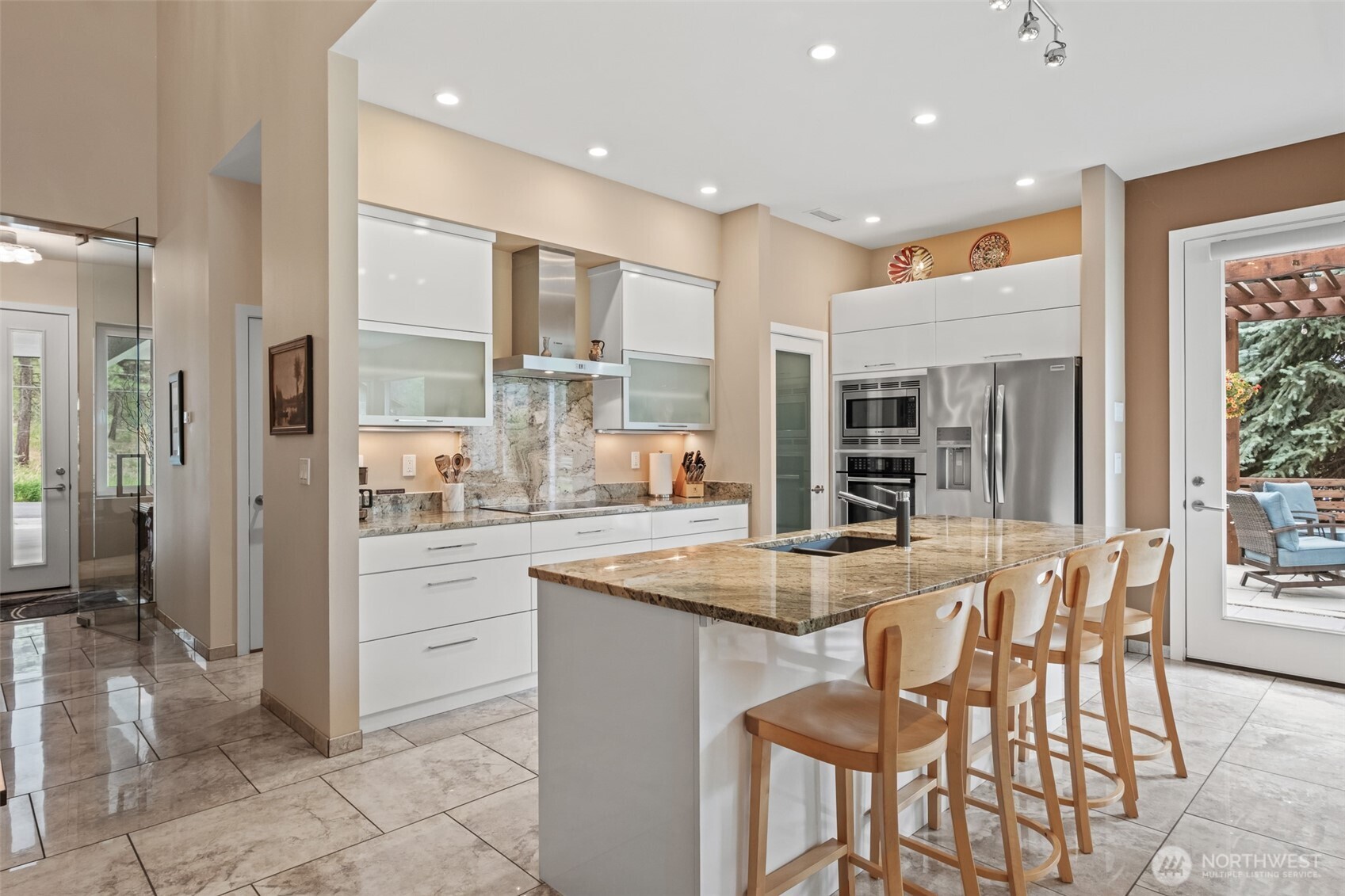 10202 Titus Road Leavenworth, WA 98826 - Photo 12 of 39 a kitchen with stainless steel appliances kitchen island granite countertop a table and chairs in it