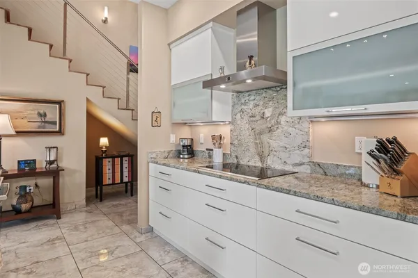 a kitchen with stainless steel appliances kitchen island granite countertop a sink and cabinets