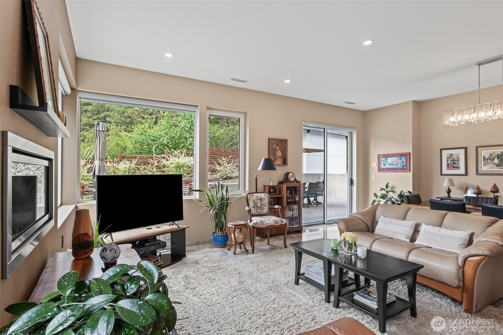 10202 Titus Road Leavenworth, WA 98826 - Photo 19 of 39 a living room with furniture a flat screen tv and a floor to ceiling window