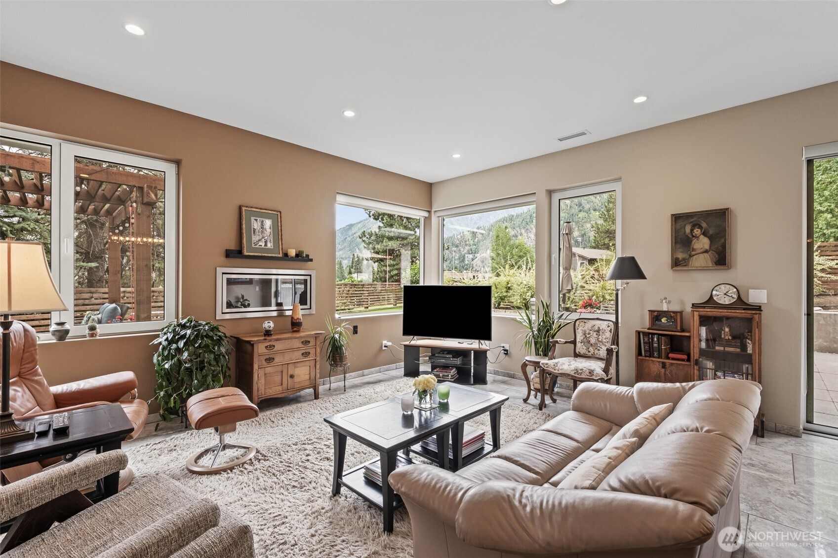 10202 Titus Road Leavenworth, WA 98826 - Photo 20 of 39 a living room with furniture a large window and a flat screen tv