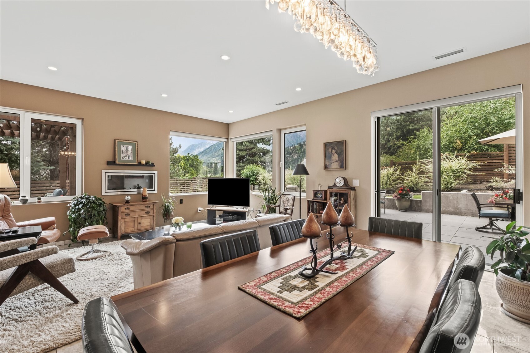 10202 Titus Road Leavenworth, WA 98826 - Photo 22 of 39 a living room with furniture a flat screen tv and a large window