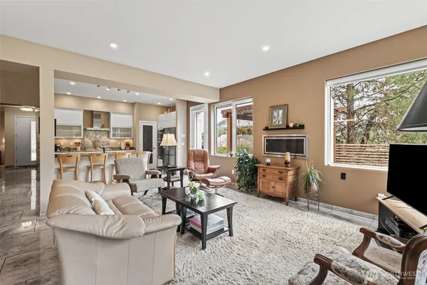 a living room with fireplace furniture and a flat screen tv