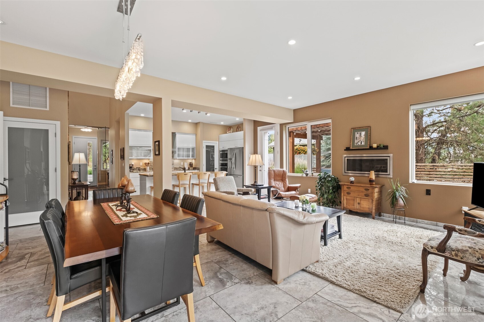 10202 Titus Road Leavenworth, WA 98826 - Photo 26 of 39 a view of a dining room with furniture a chandelier and wooden floor