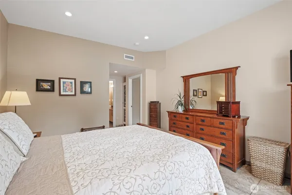 a bedroom with a bed and a dresser