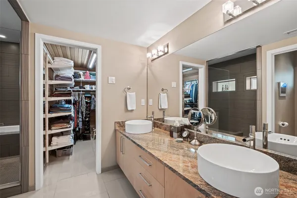 a bathroom with a double vanity sink and a mirror