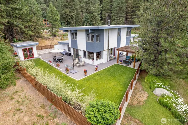 a view of house with backyard outdoor seating area and green space