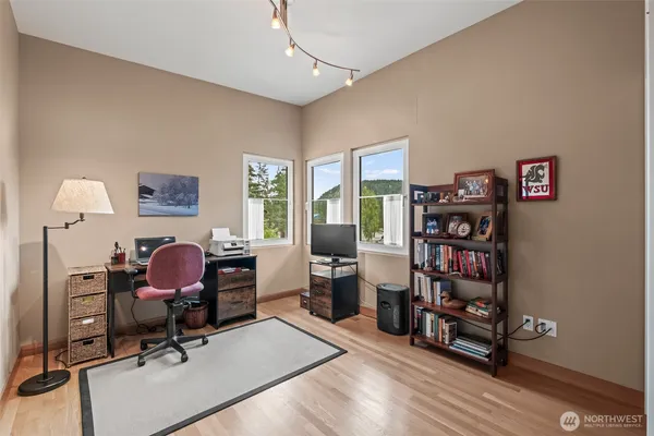 a view of a workspace with furniture and a window