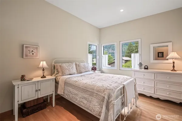 a bedroom with a bed and a large window