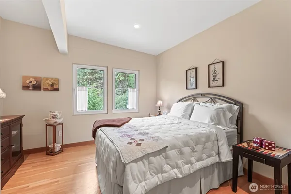 a bedroom with a bed and a table with window