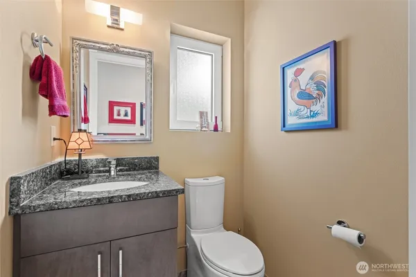 a bathroom with a toilet a sink and a mirror