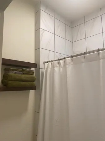 a white toilet sitting next to a shower