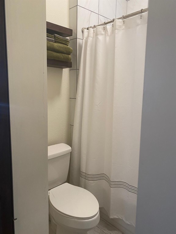 2708 Winbern Street Houston, TX 77004 - Photo 12 of 17 a white toilet sitting next to a shower