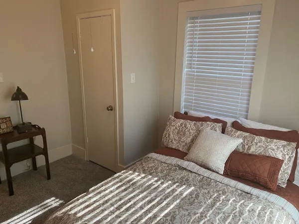 a bedroom with a bed and a window